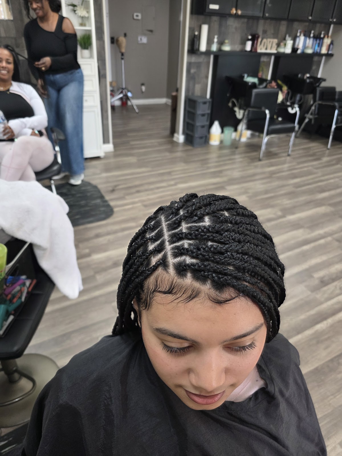 Neat box braids with triangle parts, finished in the salon